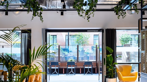 A modern indoor space with large windows, indoor plants, and seating areas. - Staycity Aparthotels, Dublin, City Centre (Dublin)