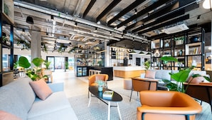 A modern interior with a sofa, chairs, a coffee table, and a bookshelf. - Staycity Aparthotels, Dublin, City Centre (Dublin)