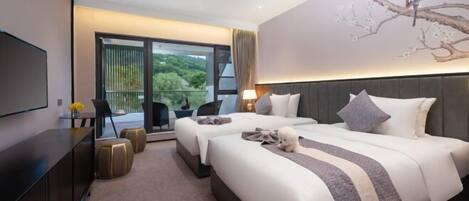 A modern hotel room with two beds, a flat-screen TV, a balcony with a view, and a painting of a tree.