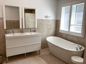Bathtub, hair dryer, towels, soap
