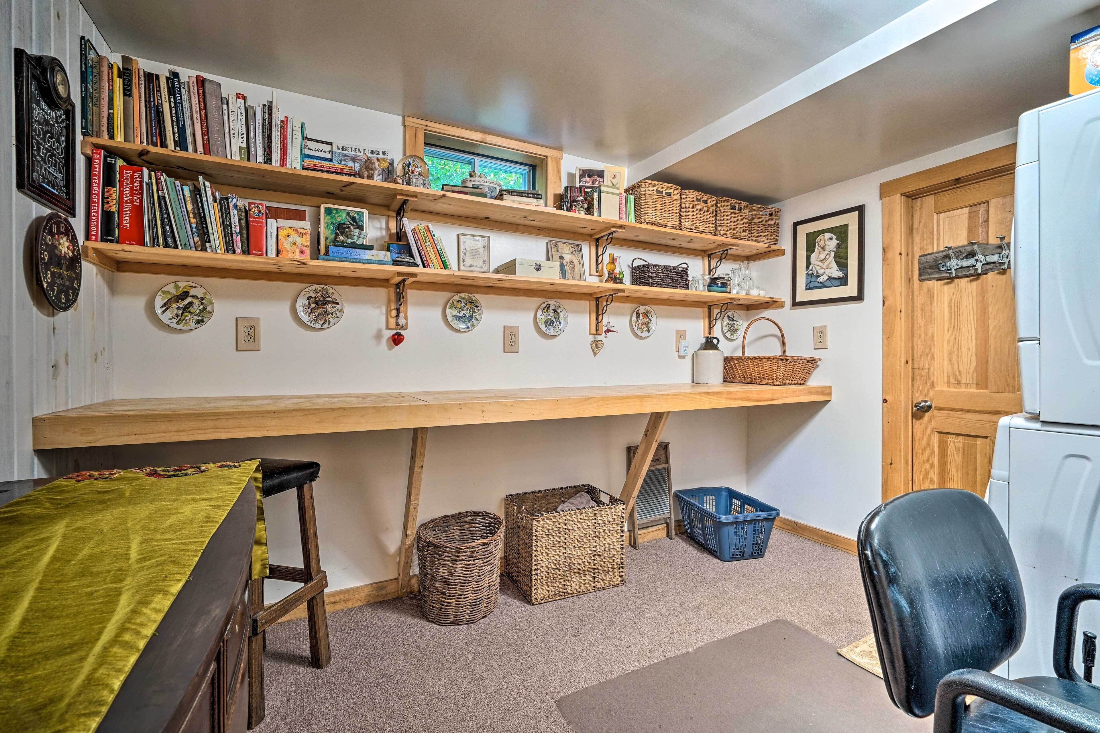 A kitchen with wooden shelves, a dining table, and a refrigerator.