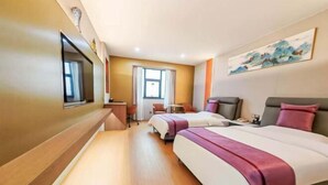 A hotel room with two beds, a desk, a chair, a TV, and a painting on the wall. - Grandhall Hotel Shishi (Shishi)