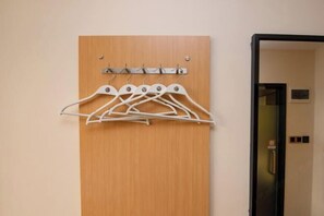 A wooden door with a metal hanger rack mounted above it.