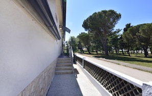 Stroll through a tranquil, park-like setting, surrounded by lush greenery and mature trees.