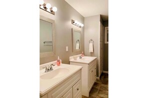 Combined shower/bathtub, towels, soap, toilet paper
