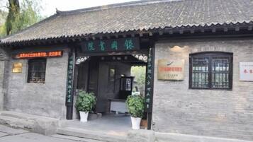 A traditional building with a tiled roof and a signboard.