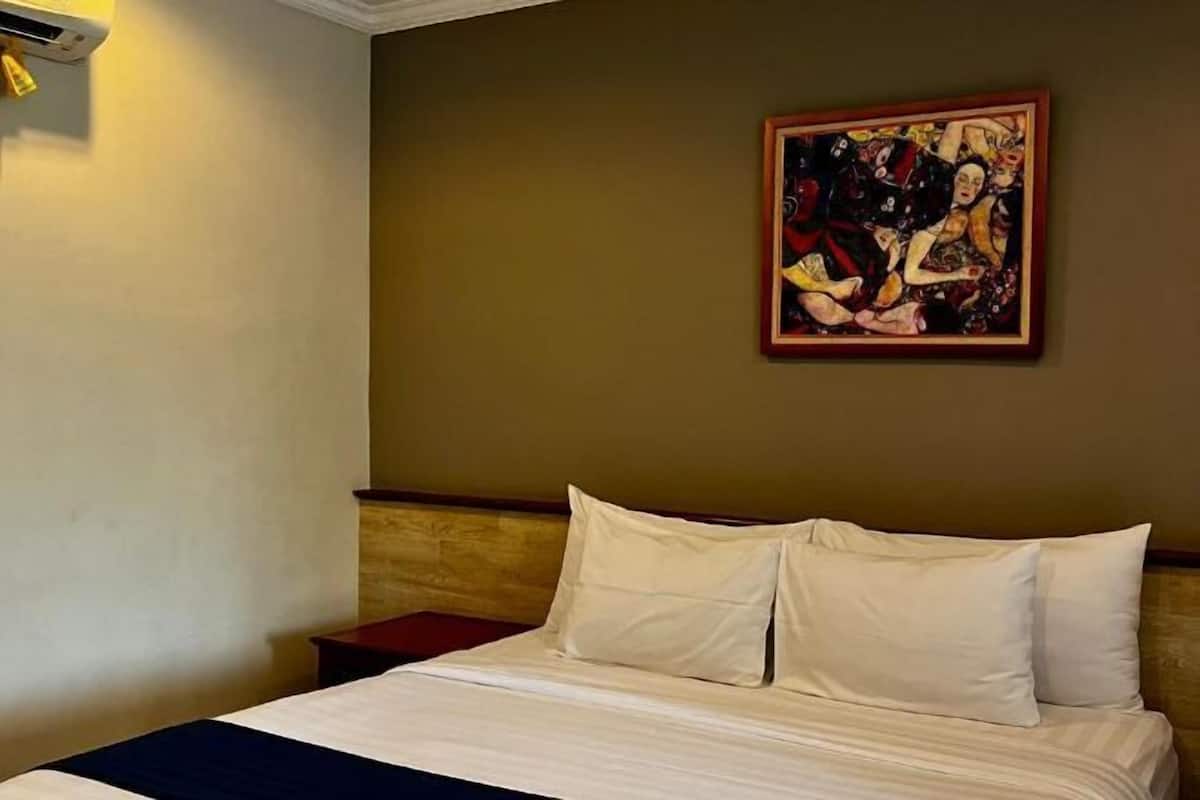 Premium bedding, memory-foam beds, laptop workspace, blackout curtains