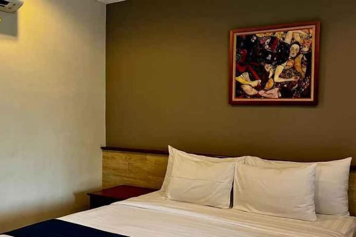 Premium bedding, memory foam beds, laptop workspace, blackout drapes