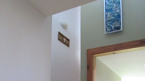 A wooden staircase with a mirror on the wall.