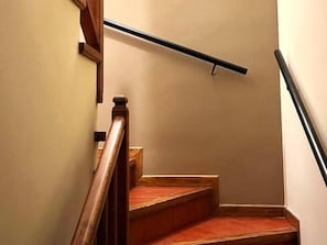 A wooden staircase with a handrail and a wooden banister.