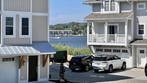 A coastal property with a garage, a covered porch, and a view of the water.