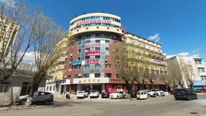 A multi-story building with various signs and advertisements on the facade.