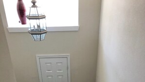 A staircase with a carpeted floor, a white door, and a wooden handrail. - Family-friendly 3 bedroom retreat, in shared house (Katy)