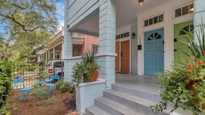 A two-story house with a porch, steps leading to the front door, and a mailbox. - Forth House - Butterfly Getaway in Historic SPR! (Jacksonville)