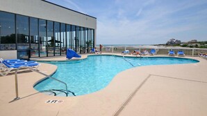 A pool area with lounge chairs and a view of the beach. - Sands Beach Club II 625 - Ocean Front 2 Bed/2 Bath Condo - Amenities: Pools, Hot Tub & Tennis Court (Myrtle Beach)