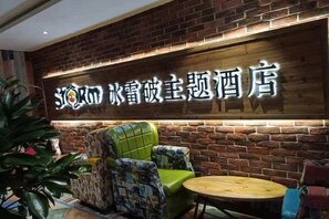 A hotel interior with a brick wall, a neon sign, and seating arrangements. - Ice Thunder Broken Internet Cafe (Jinxian)