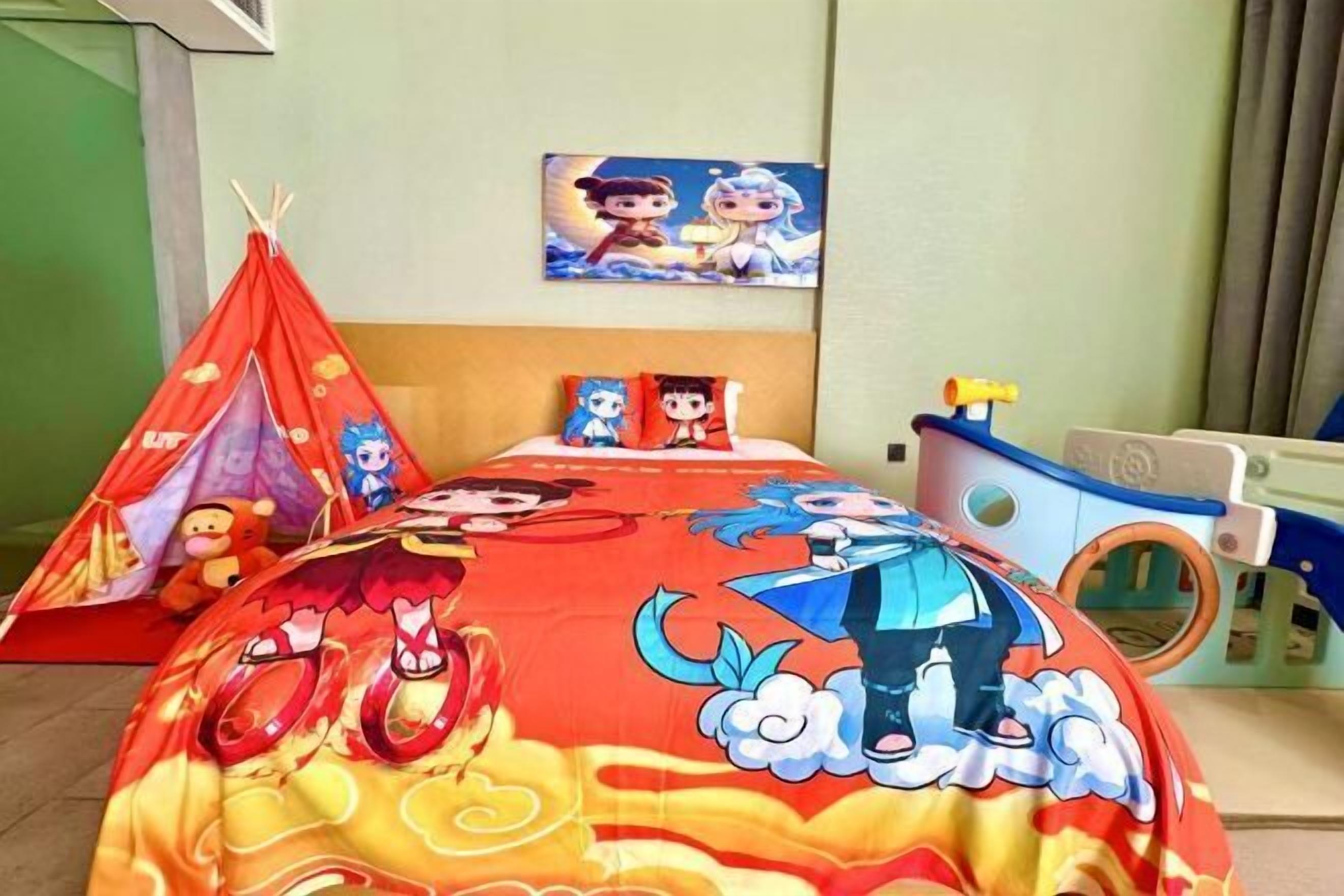 A child's bedroom with a bed, a play tent, and a wall painting.