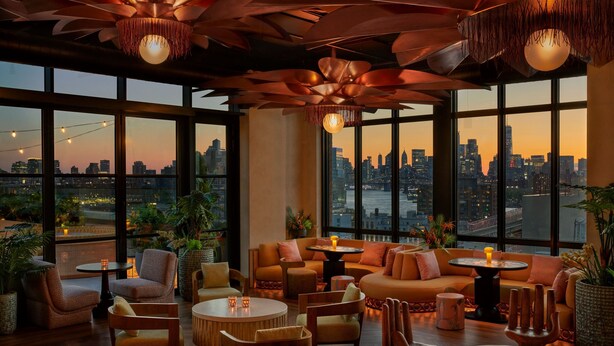 A modern lounge with large windows, comfortable seating, and decorative lighting. - Moxy Brooklyn Williamsburg (Brooklyn)