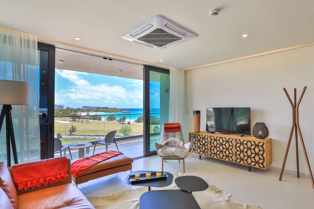 Deluxe Condo, 1 Bedroom, Balcony, Beach View | Living area | Smart TV