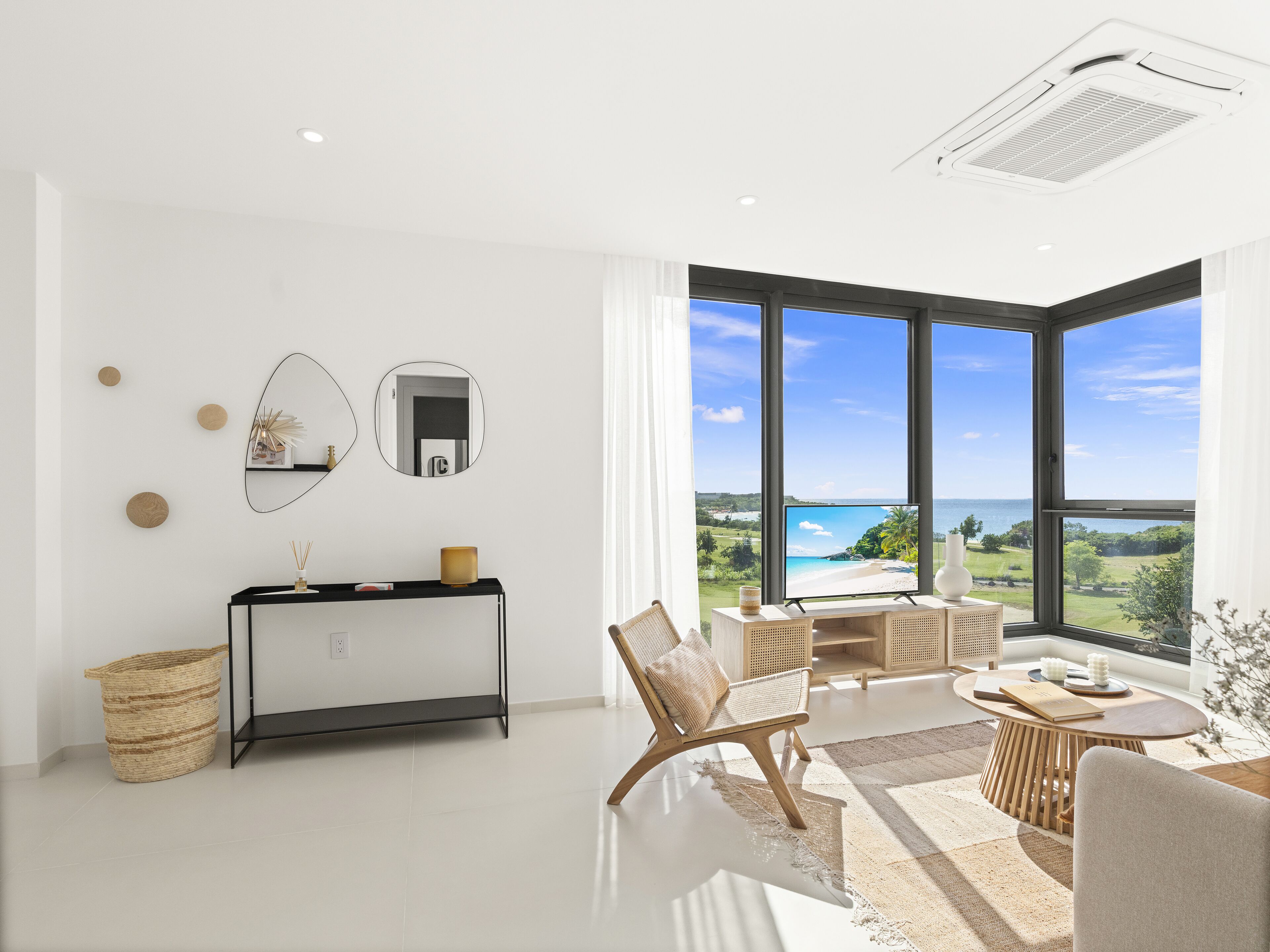 Un salon moderne avec une grande fenêtre, une console, un canapé et une vue sur la plage.