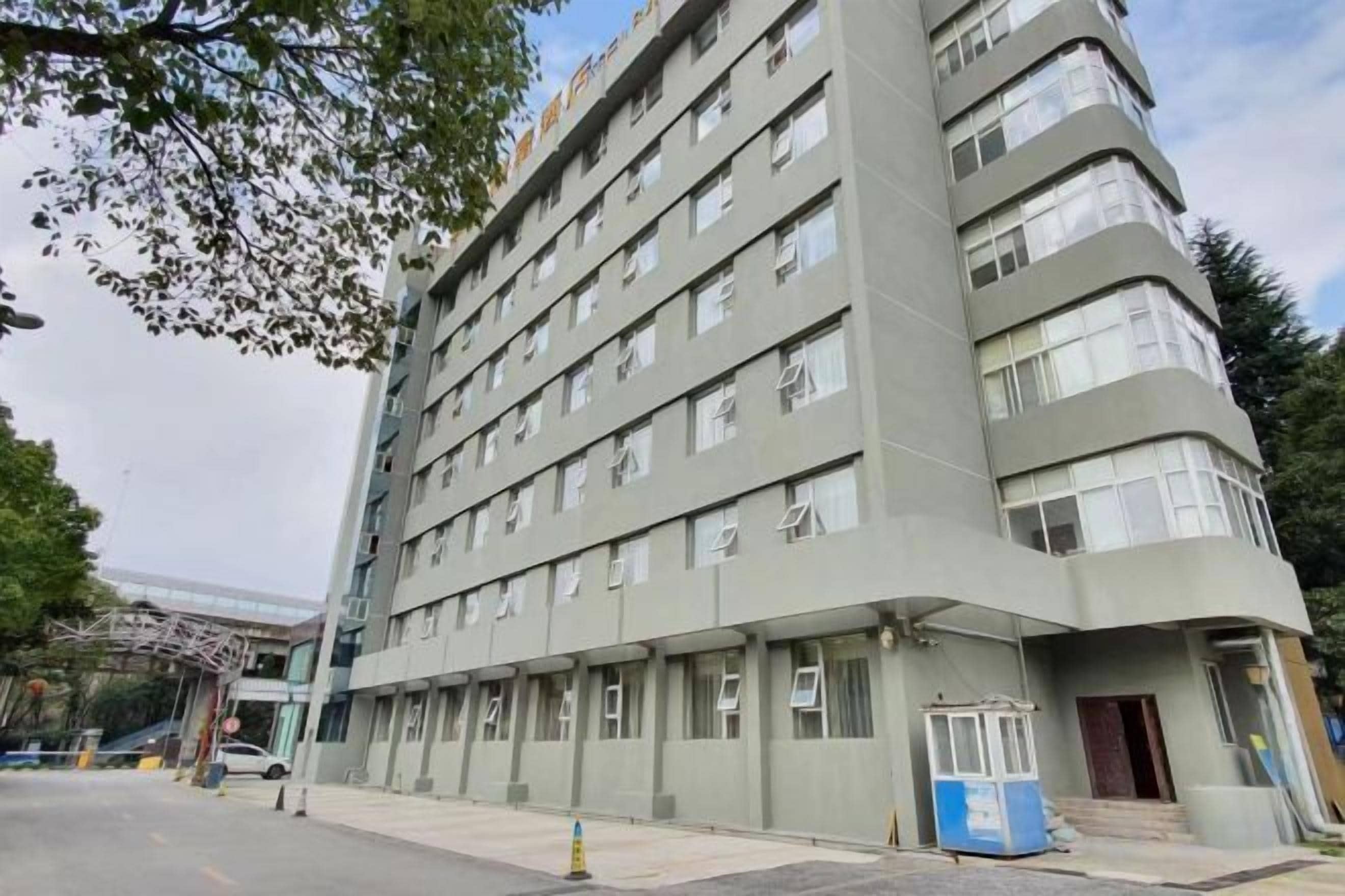 A multi-story hotel with a flat facade, numerous windows, and a ground-level entrance.