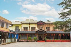 A traditional building with a central entrance, multiple windows, and a red awning. - Joy Opulence Hotel (Guiyang)