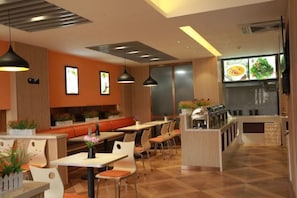 A restaurant interior with high tables, booths, and a bar area. - Yashe Tianxiang Boutique Hotel (Jiaohe)