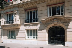 A building with a classical architectural style, featuring ornate balconies and a large, decorative entrance.