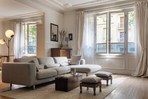A living room with a sofa, coffee table, and decorative items.