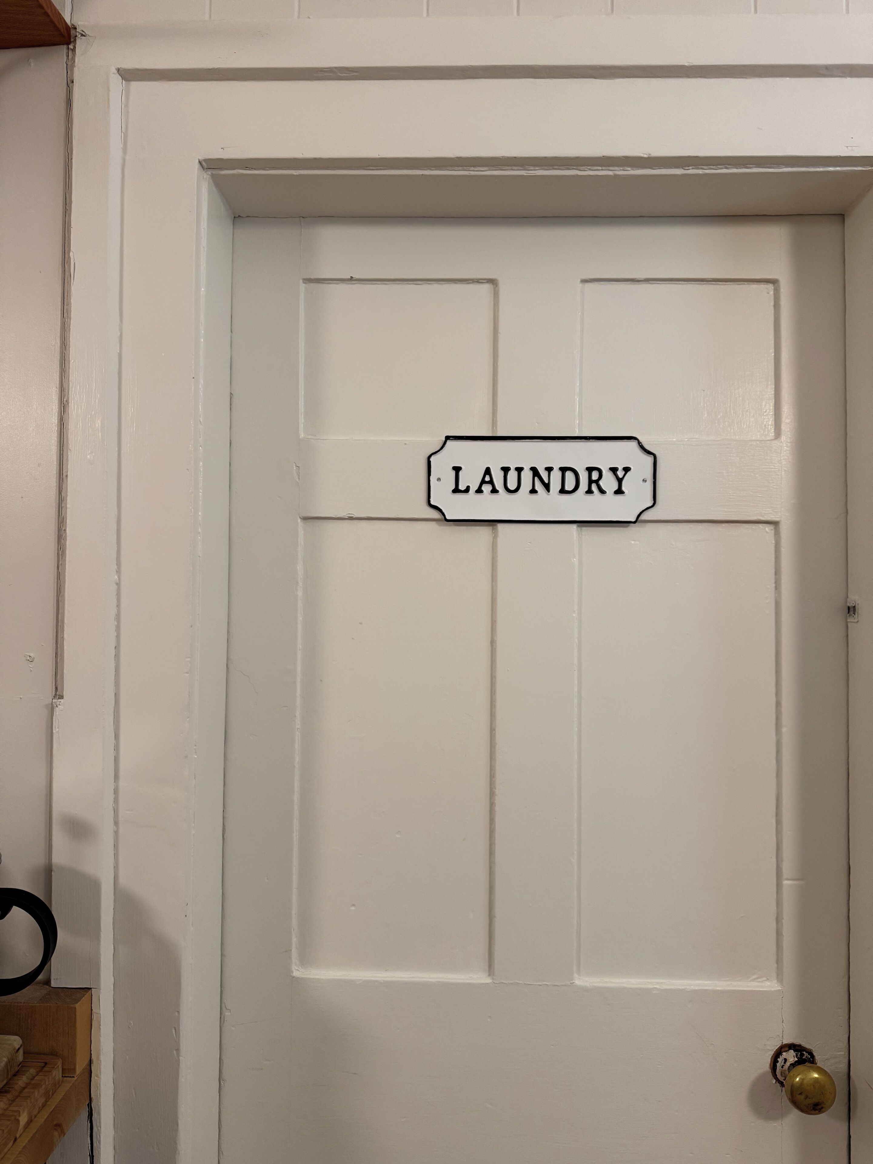 Une porte blanche avec une pancarte indiquant « LAUNDRY ».