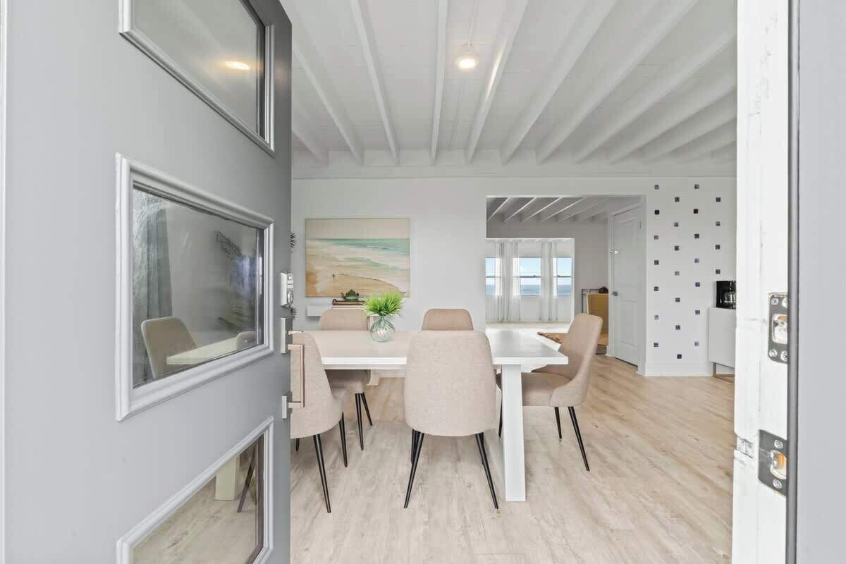 A modern interior with a dining area, a kitchen, and a living space.