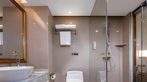 A modern bathroom with a large sink, toilet, and glass-enclosed shower. - Vienna 3 Best Hotel (Guilin)