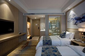 A hotel room with two beds, a TV, a bathroom with a glass door, and a painting on the wall. - Shengyang Hotel (Yuxi)