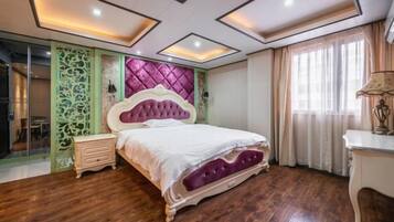 A bedroom with a bed, a nightstand, a dresser, a decorative headboard, and a window with curtains.