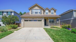 A single-story residential house with a garage, a front porch, and a well-maintained lawn. - Beautiful 3 bedroom home with theater! (Littleton)