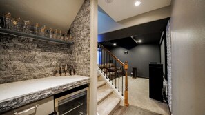 A kitchen with a stone backsplash, a countertop, and a built-in oven.