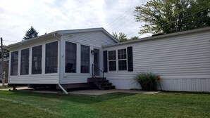 A single-story house with a covered porch and a small staircase leading to the front door. - Silver Lake - 4th of July - Lake Access - MIS (Addison)