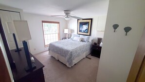 A bedroom with a bed, a ceiling fan, a window, a nightstand, and a lamp. - Silver Lake - 4th of July - Lake Access - MIS (Addison)