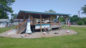 A boat house with a covered deck and a small lighthouse. - Quaint cozy little cabin geared for folks coming to Leech Lake to fish or relax. (Federal Dam)