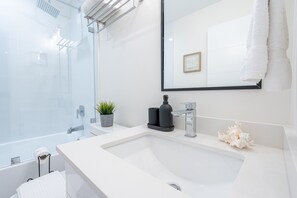 Combined shower/bathtub, hair dryer, towels, soap