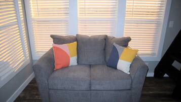 Deluxe Cottage, 1 Bedroom, Bay View | Living area | 40-inch flat-screen TV with cable channels, TV, fireplace