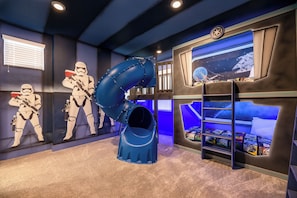 A room with Star Wars-themed decor, including a slide, bunk beds, and space-themed wall art. - Amazing New Villa!  Exceptionally Maintained! Fun for the Whole Family! (Four Corners)