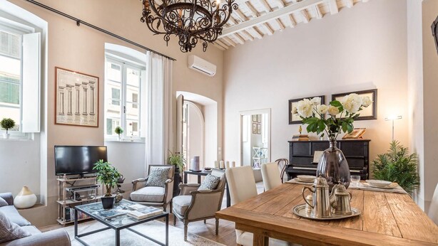 A spacious living room with a wooden dining table, comfortable seating, a television, and a chandelier. - Casa Janca in Lucca With 1 Bedrooms and 2 Bathrooms (Lucca)