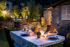 Enjoy a romantic dinner for two in our serene garden setting, complete with a beautifully set table and stunning views.