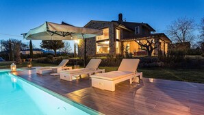 A poolside area with lounge chairs and a covered seating area. - Villa Otto in Orentano (Castelfranco di Sotto)