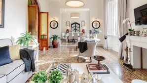 A spacious living room with a checkered floor, a sofa, a coffee table, and a fireplace. - The Park View Apartment (Lucca)