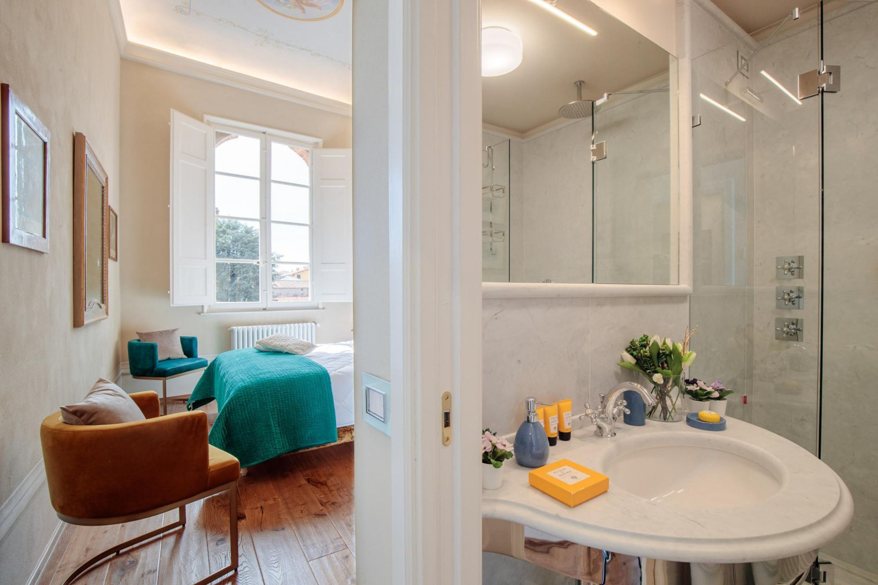 A modern bathroom with a large mirror, a white sink, and a shower area.