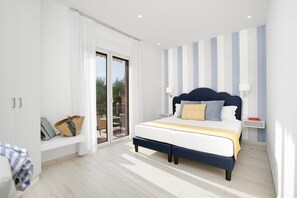 A modern bedroom with a large bed, a bench with a basket, a sliding glass door to a balcony, and a striped wall. - Sara Home 1 in Sorrento (Sorrento)
