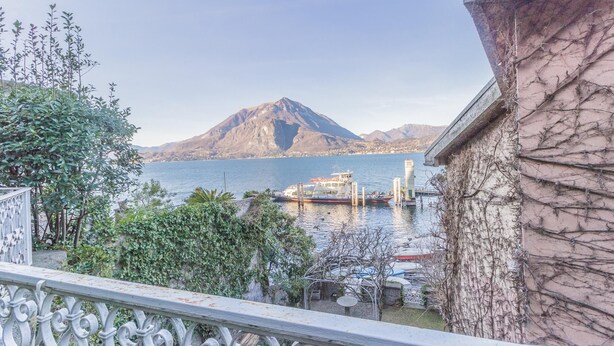 A balcony with a view of a mountain and a body of water. - Varenna Garden in Varenna (Varenna)