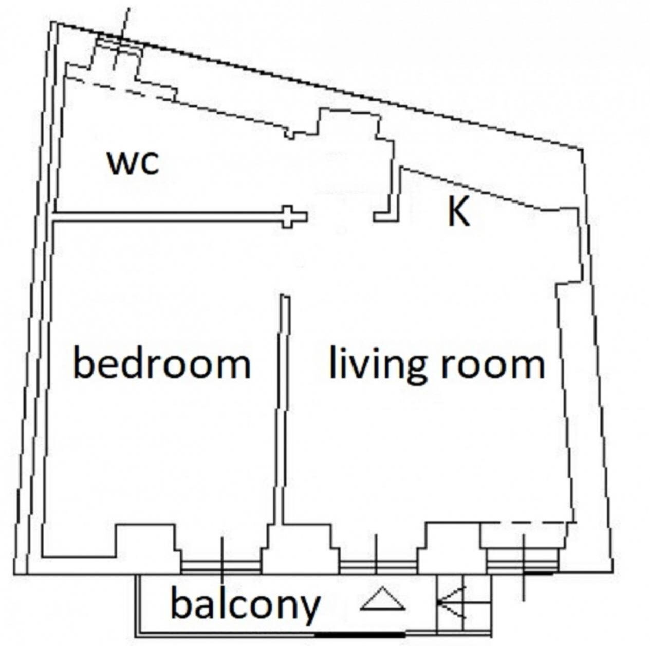 A floor plan with a bedroom, living room, balcony, and WC.
